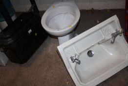A CERAMIC TOILET AND SINK TOGETHER WITH A BAKELITE TOILET CISTERN