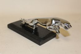 A JAGUAR CAR MASCOT ON MARBLE BASE