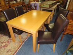 A MODERN DINING TABLE AND FOUR CHAIRS