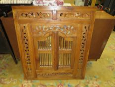 AN EASTERN HARDWOOD CARVED AND PIERCED WALL MIRROR WITH SHUTTER STYLE DOORS H-88 CM W-79 CM