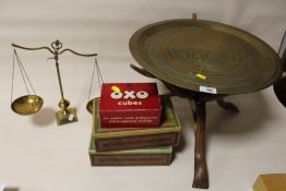 A BRASS TOPPED TRIPOD TABLE WITH A SET OF BRASS SCALES AND THREE TINS