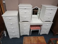 A MODERN WHITE BEDROOM DRESSING TABLE, TRIPLE MIRROR, STOOL, TALL CHEST AND TWO BEDSIDE CHESTS (6)