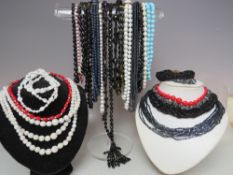A COLLECTION OF VINTAGE CERAMIC AND GLASS BEAD NECKLACES., various styles and periods comprising