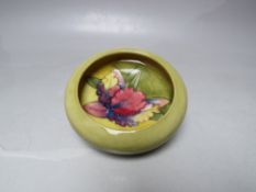 A MOORCROFT CIRCULAR DISH OF SMALL PROPORTIONS, impressed marks under glaze to base, approx Dia..