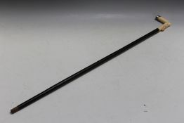 AN ANTIQUE CARVED IVORY HANDLED CARVED STAG HANDLED WALKING CANE, circa mid to late 19th century,