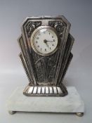 AN EARLY 20TH CENTURY FRENCH SILVER PLATED MANTLE CLOCK, the Art Deco style case raised on a