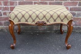 AN ANTIQUE MAHOGANY RECTANGULAR STOOL, having a modern upholstered seta, supported by four slender