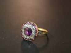 AN ANTIQUE MOURNING RING, set with amethysts and diamonds along with woven hair under a crystal,