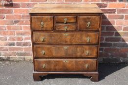 A 19TH CENTURY OAK AND WALNUT CHEST OF DRAWERS, with an unusual arrangement of four smaller
