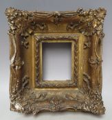 A 19TH CENTURY GOLD SWEPT PORTRAIT MINIATURE FRAME, frame W 8 cm, rebate 11 x 9 cm