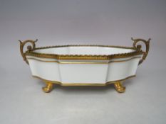 A SHAPED PORCELAIN DISH BY LIMOGES OF FRANCE, with hand painted highlights and gilt mounts and