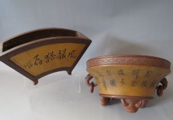 A CHINESE POTTERY FLARED CIRCULAR PLANTER, raised of three outswept feet , with applied mask and