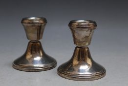 A PAIR OF MODERN HALLMARKED SILVER SQUAT CANDLESTICKS - BIRMINGHAM 1992, having filled bases, H 6.