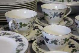 A LARGE COLLECTION OF ROYAL DOULTON 'BURGUNDY' PATTERN TEA AND DINNERWARE, comprising 12 tea cups,