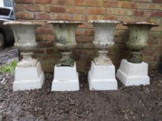A SET OF FOUR ANTIQUE CAST METAL CAMPANA URNS ON LATER BASES, the urns of typical form, overall H 75