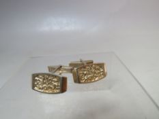 A PAIR OF MID 20TH CENTURY HALLMARKED STERLING SILVER CUFFLINKS, with modernist textured effect to