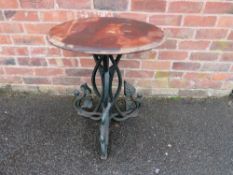 A MID 20TH CENTURY CAST IRON PEDESTAL GARDEN TABLE WITH LATER MAHOGANY TOP the circular top raised