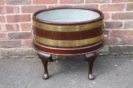 A REPRODUCTION MAHOGANY OVAL WINE COOLER IN THE GEORGIAN STYLE, having modern tin removable liner,