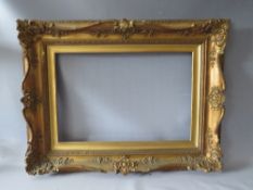 A 19TH CENTURY DECORATIVE GOLD SWEPT FRAME WITH GOLD SLIP, frame W 10 cm, slip rebate 61 x 41 cm,