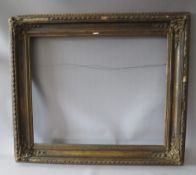 A 19TH CENTURY DECORATIVE GOLD FRAME WITH CORNER EMBELLISHMENTS, frame W 10 cm, rebate 56 x 69 cm