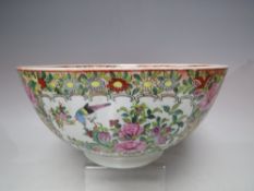 AN ORIENTAL FAMILLE ROSE CIRCULAR FOOTED BOWL, profusely decorated and fruit, foliate and various