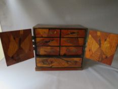 AN ORIENTAL INLAID TABLE CABINET, having two doors and single drawer, the doors opening to reveal