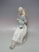 A LARGE LLADRO FIGURINE 'EMBROIDERY LADY' DEPICTING A SEATED LADY SEWING A TAPESTRY, H 28 cm