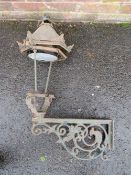 A CAST IRON EXTERIOR / COURTYARD LANTERN ON WALL BRACKET, with copper hood, approx. overall H 98 cm,