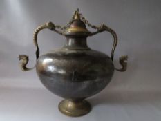 A LARGE VINTAGE EASTERN METAL DECORATIVE LIDDED VESSEL, with applied mask embellished handles, H