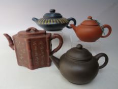 A SELECTION OF ORIENTAL TERRACOTTA TEAPOTS ETC., to include an hexagonal example with relief