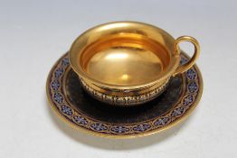 A SEVRES TYPE HIGHLY GILDED CABINET CUP AND SAUCER, on cobalt blue background, marks to both cup and
