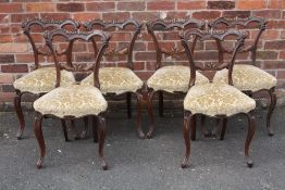 A SET OF SIX VICTORIAN MAHOGANY CROWN BACKED DINING CHAIRS, with carved top and mid rails, raised on