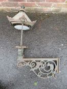 A CAST IRON EXTERIOR / COURTYARD LANTERN ON WALL BRACKET, with copper hood, approx. overall H 98 cm,
