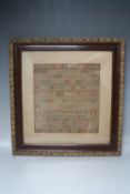 A 19TH CENTURY FRAMED AND GLAZED SAMPLER, by ANN WILDING Aged 8 and dated 1836, 30 x 28 cm