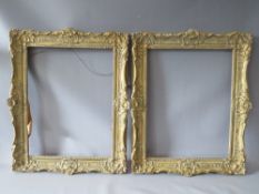 A PAIR OF 20TH CENTURY DECORATIVE GILT SWEPT FRAMES, frame W 7 cm, rebate 51 x 39 cm