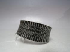 A HANDMADE DANISH PEWTER BANGLE BY JORGE JENSEN, stylised engraved pattern to front, marks to