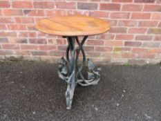 A MID 20TH CENTURY CAST IRON PEDESTAL GARDEN TABLE WITH LATER OAK TOP the circular top raised on