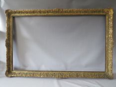 A LATE 19TH / EARLY 20TH CENTURY DECORATIVE GOLD FRAME WITH WOODEN SLIP, frame W 7 cm, slip rebate