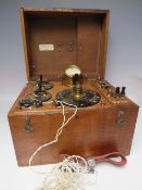 AN EARLY 20TH CENTURY OAK CASED ELECTRO - MEDICAL THERAPY MACHINE BY THE CAVENDISH ELECTRICAL Co.