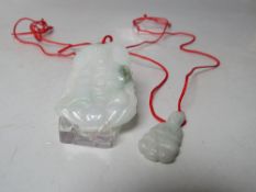 TWO JADE FIGURAL PENDANTS , the largest depicting a Buddha seated on a lotus flower, H 5 cm, both