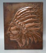 A TWENTIETH CENTURY EMBOSSED COPPER PLAQUE of a native American Indian with headdress, 25 x 20 cm