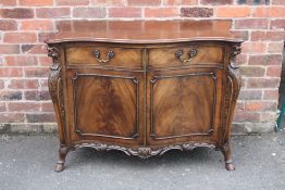 A REPRODUCTION MAHOGANY SERPENTINE FRONTED CABINET IN THE CHIPPENDALE STYLE, with carved detail to