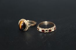 A HALLMARKED 9 CARAT GOLD 'TIGERS EYE' RING, together with a garnet and pearl ring with stones