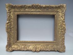 A LATE 18TH / EARLY 19TH CENTURY CARVED WOODEN GOLD DECORATIVE FRAME, frame W 8 cm, rebate 34 x 24