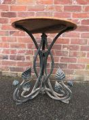 A MID 20TH CENTURY CAST IRON PEDESTAL GARDEN TABLE WITH LATER OAK TOP the circular top raised on