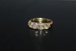 AN 18CT OLD CUT FIVE STONE DIAMOND RING, the five stones total an estimated 1.25 carats but there