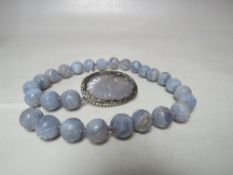 A CARVED JADE BEAD NECKLACE WITH RELIEF CARVED PANEL CLASP, individual beads approx. Dia. 1.5 cm,