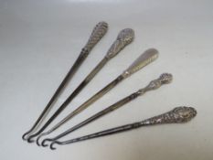 A COLLECTION OF FIVE SILVER HANDLED BUTTON HOOKS, various marks and makers, longest L 29.5 cm
