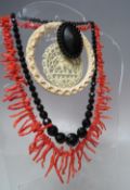 A VINTAGE CORAL STRAND NECKLACE, L 48 cm, together with a Victorian jet brooch, a single graduated