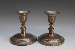 A DECORATIVE PAIR OF HALLMARKED SILVER CANDLESTICKS WITH WIDE BASE - LONDON 1961, having a filled